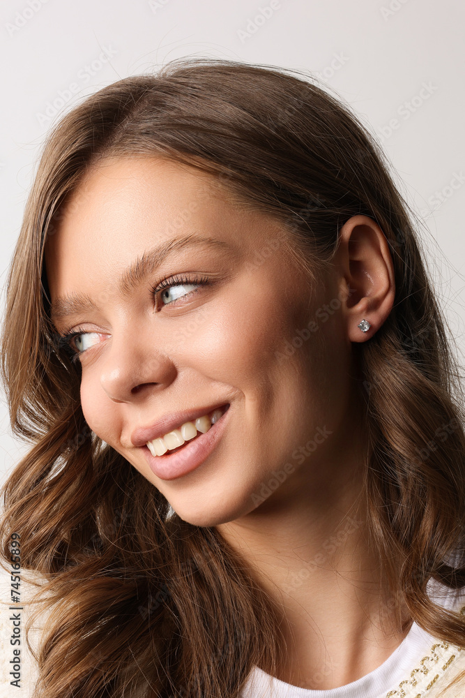 Beautiful young girl with fresh healthy skin. Woman advertise ear-rings. White background. Earrings closeup. Blond european woman with long hair with big lips, pretty smile. Cosmetology, scincare Beautiful young girl with fresh healthy skin. Woman advertise ear-rings. White background. Earrings closeup. Blond european woman with long hair with big lips, pretty smile. Cosmetology, scincare