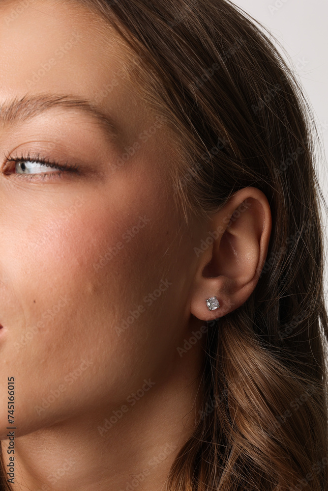 Beautiful young girl with fresh healthy skin. Woman advertise ear-rings. White background. Earrings closeup. Blond european woman with long hair with big lips, pretty smile. Cosmetology, scincare Beautiful young girl with fresh healthy skin. Woman advertise ear-rings. White background. Earrings closeup. Blond european woman with long hair with big lips, pretty smile. Cosmetology, scincare