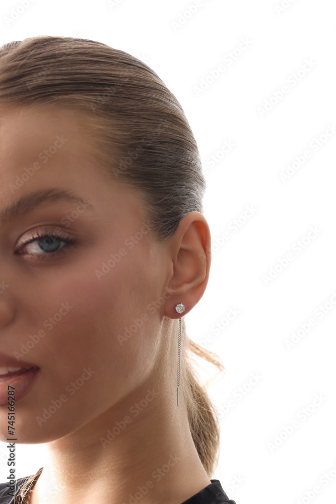Beautiful young girl with fresh healthy skin. Woman advertise ear-rings. White background. Earrings closeup. Blond european woman with long hair with big lips, pretty smile. Cosmetology, scincare Beautiful young girl with fresh healthy skin. Woman advertise ear-rings. White background. Earrings closeup. Blond european woman with long hair with big lips, pretty smile. Cosmetology, scincare