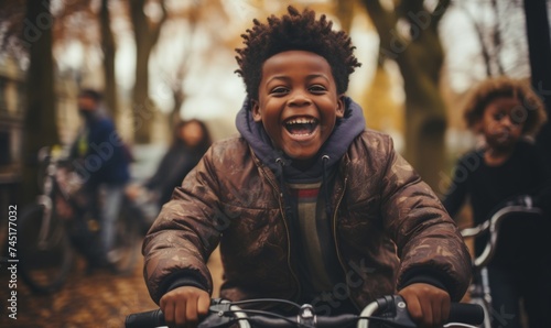 Portrait of an happy african american boy on a bicycle in the park. Paris