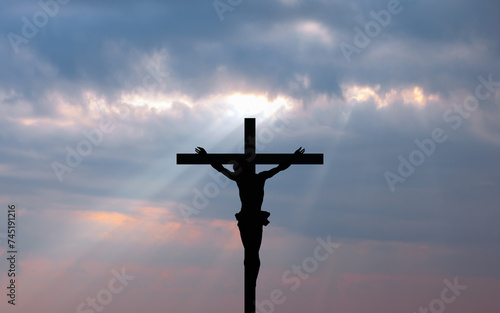 Jesus on the cross at amazing sunset