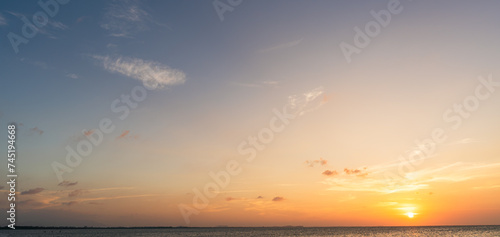 Photography Sunset sky clouds over sea in the evening on golden hour sundown or orange sunri