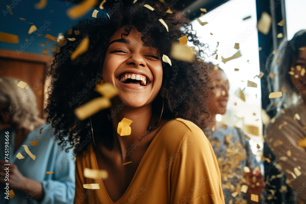 Fototapeta premium Happy African woman laughs under a rain of golden confetti