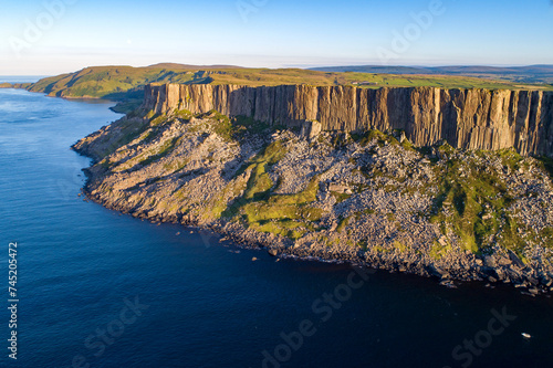 Fair Head or Benmore big cliff and headland at the Atlantic coast of County Antrim, Northern Ireland, UK,  in sunset light.