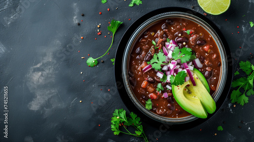Chili con carne in bowl on dark background. Top view with copy space