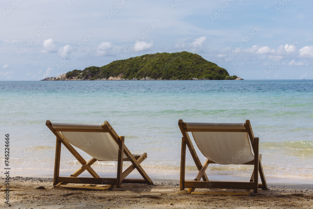 Two chairs on the beach.  Chairs on the sandy beach near the sea. Summer holiday and vacation concept for tourism.