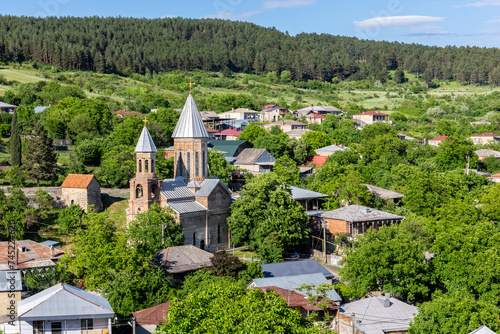 Landscape of Surami, small town (daba) in Georgia, Shida Kartli region with rural architecture and Surami St. George, Armenian orthodox church. photo