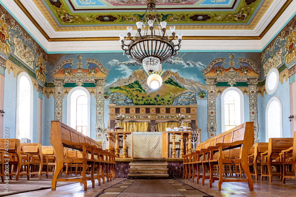 Kutaisi Synagogue inside view of nave and altar with wooden benches and richly decorated walls with colorful paintings, Georgia - obrazy, fototapety, plakaty 