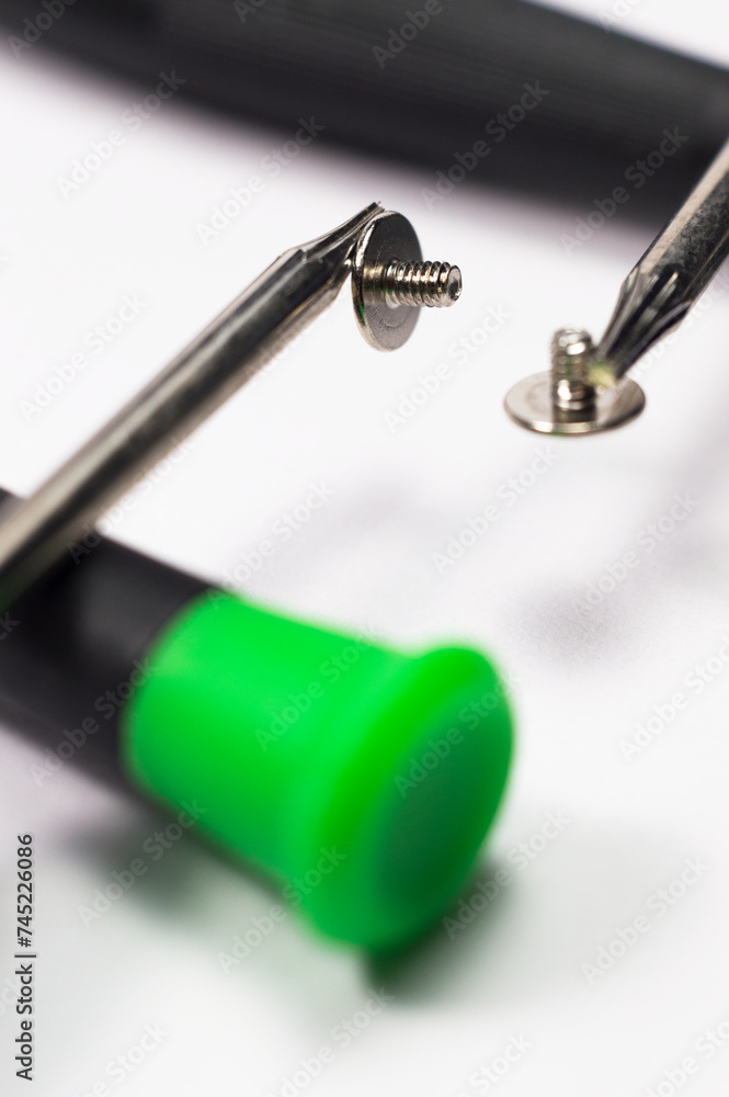 Magnetic screwdrivers with screws on a white surface, isolated Magnetic screwdrivers with screws on a white surface, isolated