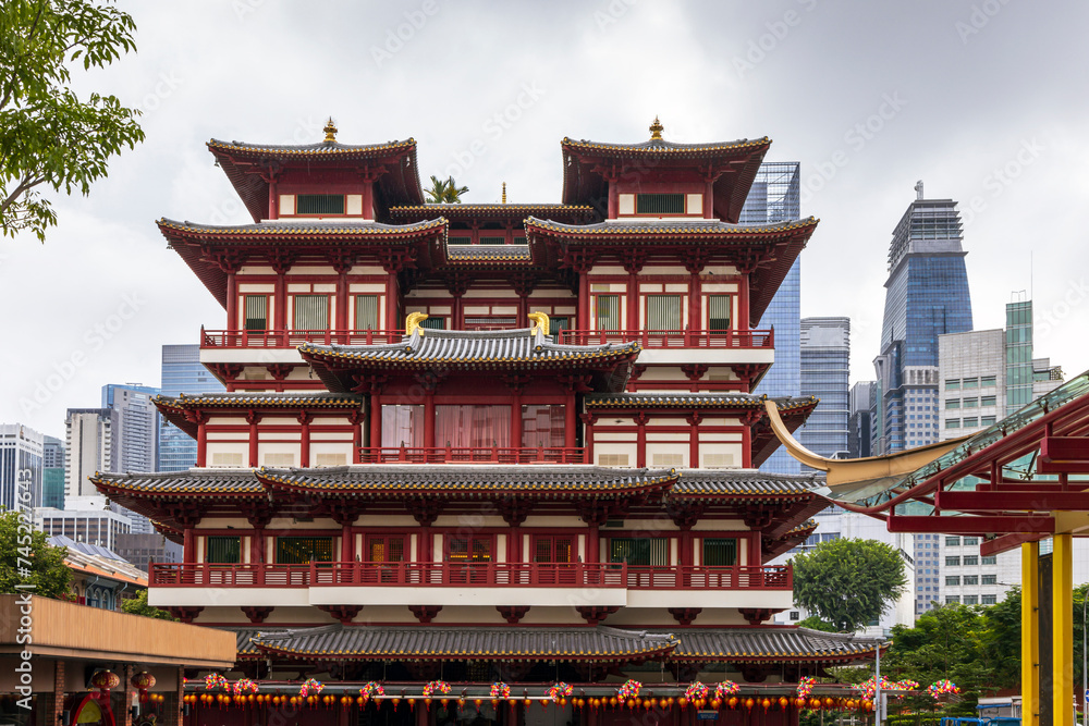 Buddha Tooth Relic Temple in Chinatown, Singapore, with Singapore`s business district in the background. Buddha Tooth Relic Temple in Chinatown, Singapore, with Singapore`s business district in the background.