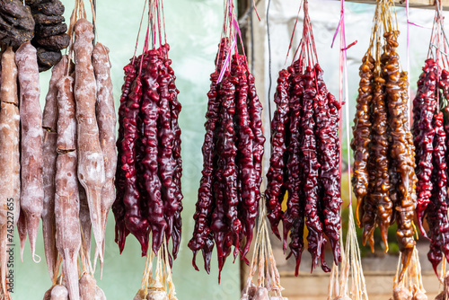 Churchkhela, traditional Georgian candle-shaped candy made of grape must, nuts, and flour, hanging on a market stall in Kutaisi Central Market (Green Bazaar,  Mtsvane Bazari). photo