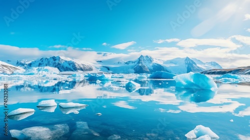 Icebergs reflecting in calm sea water under blue sky in daylight