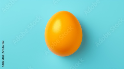 Minimalist orange egg yolk on blue background