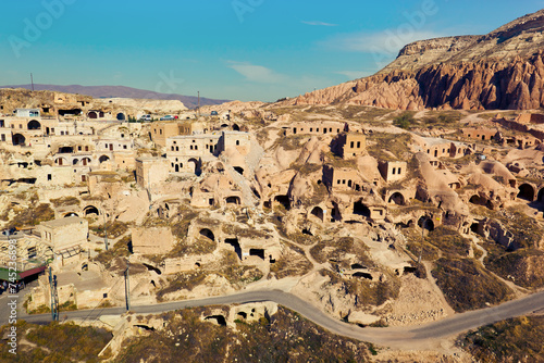View of ancient cave houses of small town Çavuşin. Nevşehir Province, Cappadocia, Turkey