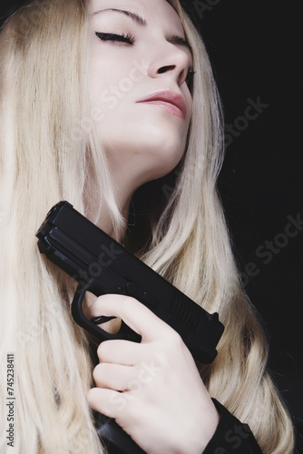 A beautiful woman holding a gun
