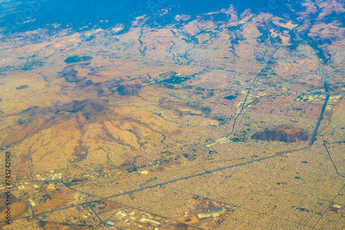 Flying airplane over Mexico Clouds Sky Volcanoes Mountains City desert.