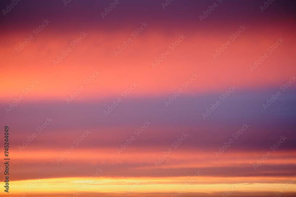 Abstract background of beautiful pink and violet sunset sky with clouds.