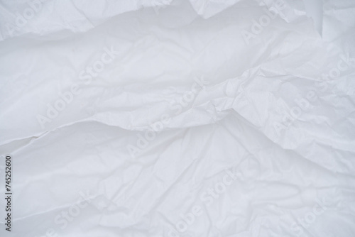 Softly crumpled white paper texture with subtle folds and creases, great for creative backgrounds and overlays.