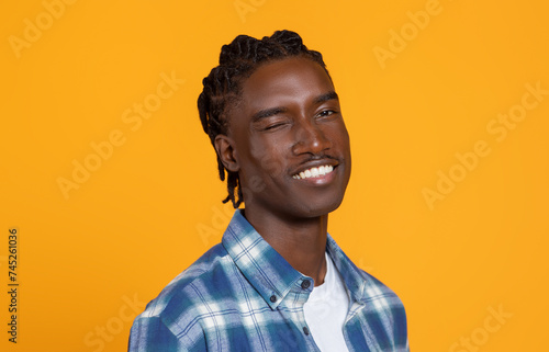 Fotografie Confident handsome young blank man winking and smiling at camera