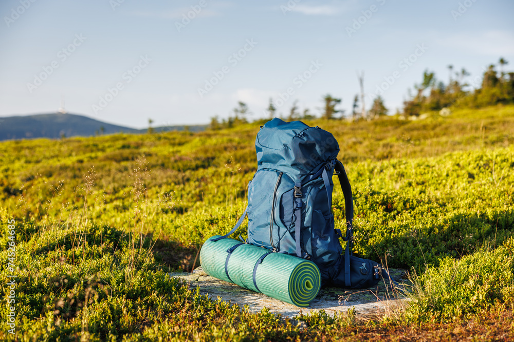 Hiking backpack with mat during trek in mountains. Camping and trekking equipment Hiking backpack with mat during trek in mountains. Camping and trekking equipment
