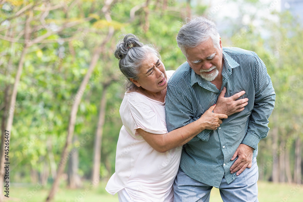 asian senior man suffering and having chest pain from heart attack in the park asian senior man suffering and having chest pain from heart attack in the park