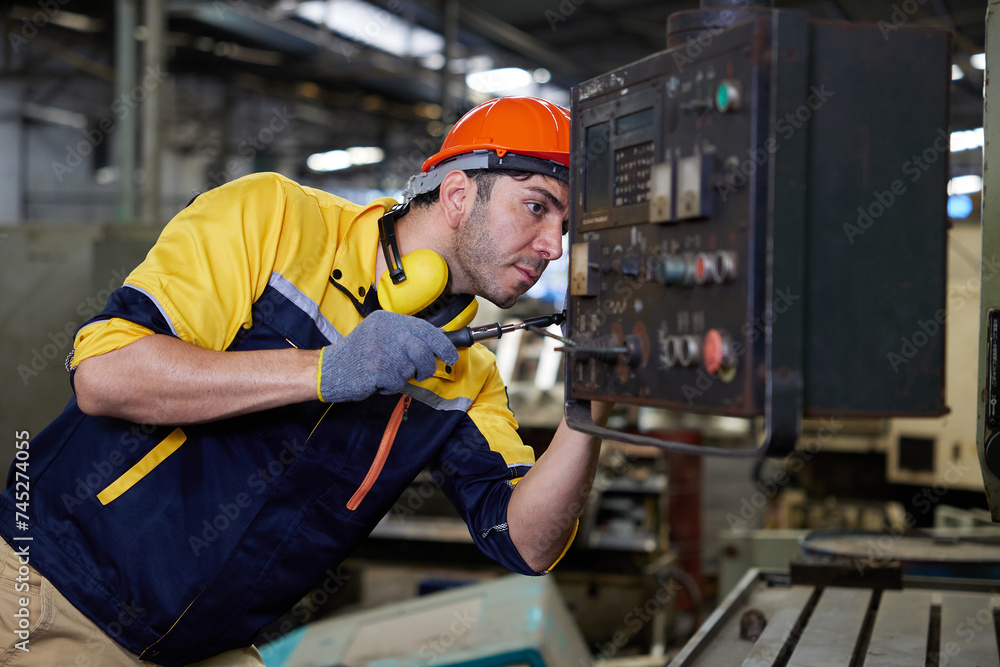 engineer or technician fixing lathe machine in the factory engineer or technician fixing lathe machine in the factory
