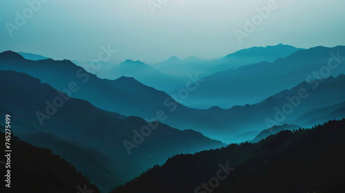 Layered blue mountain ranges in mist creating a serene and mystical landscape.