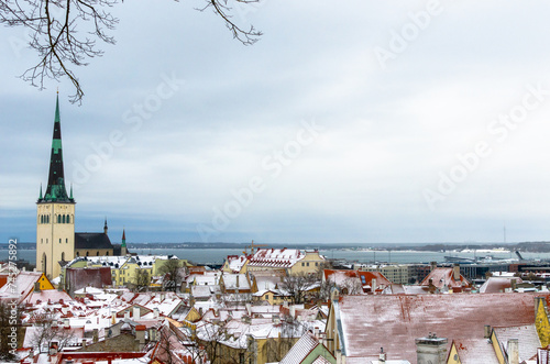 View of St. Olaf's Church and the Old Town buildings in Tallinn in Winter, Estonia