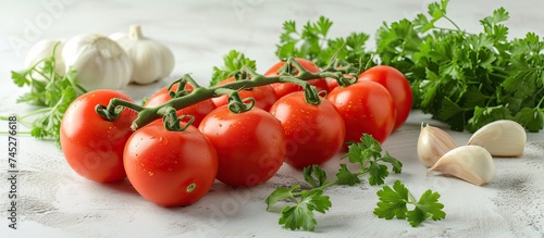 A variety of fresh tomatoes and garlic displayed on a wooden table. The vibrant red tomatoes contrast with the white garlic bulbs and green parsley leaves.
