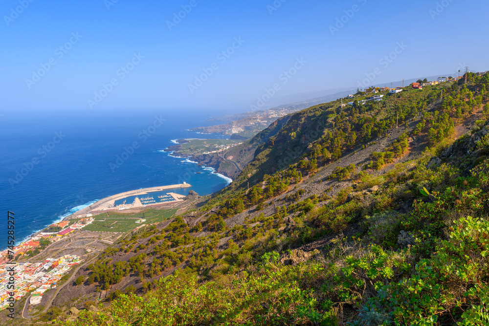 High angle panoramic view of the Northern coast near Garachico, Spain, with Punta de la Sabina and El Guincho in view along the volcanic coast on the Canary Island of Tenerife. High angle panoramic view of the Northern coast near Garachico, Spain, with Punta de la Sabina and El Guincho in view along the volcanic coast on the Canary Island of Tenerife.