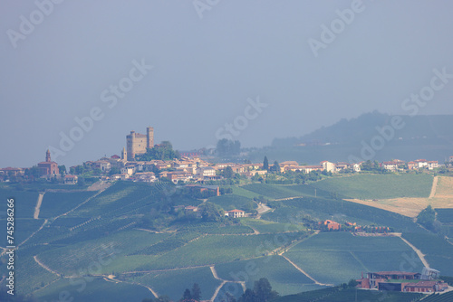 typical piedmontese landscape with a small village on the top of a hill photo