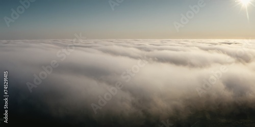 Panoramic view of an abstract fog with white cloudiness moving on a black background with copy space for text © SANTANU PATRA