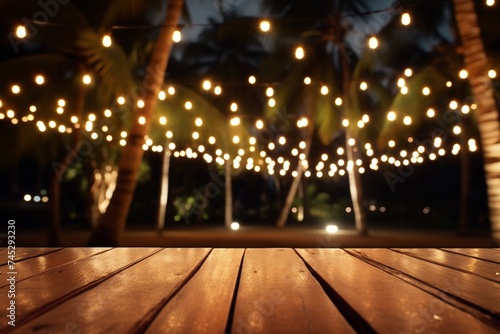 Outdoor string lights hanging on tree, fairy lights on wood table top in garden at night