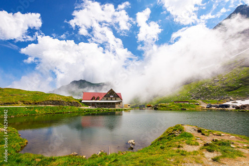 balea lake of romania in summer. sunny weather with stunning clouds on the blue sky. alpine landscape of fagaras mountains