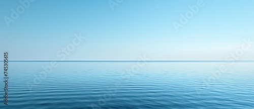 a large body of water with a boat in the middle of the water and a blue sky in the background.