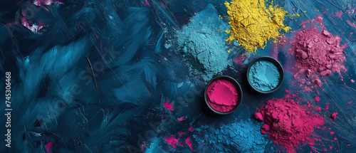 Top view of colorful Holi powder in bowls on a blue background with copy space for text, Happy Holi festival banne