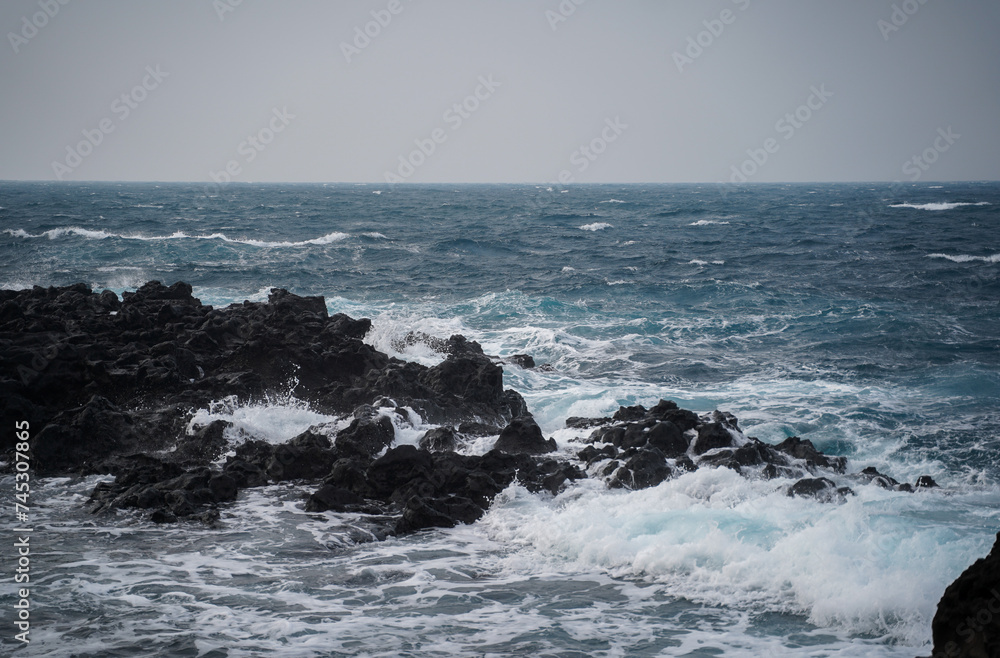 Blue sea and black rock.
The basalt and sea are beautiful.