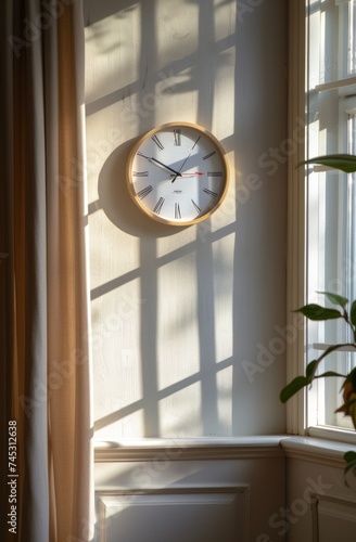 a clock with a sunlit background near a window