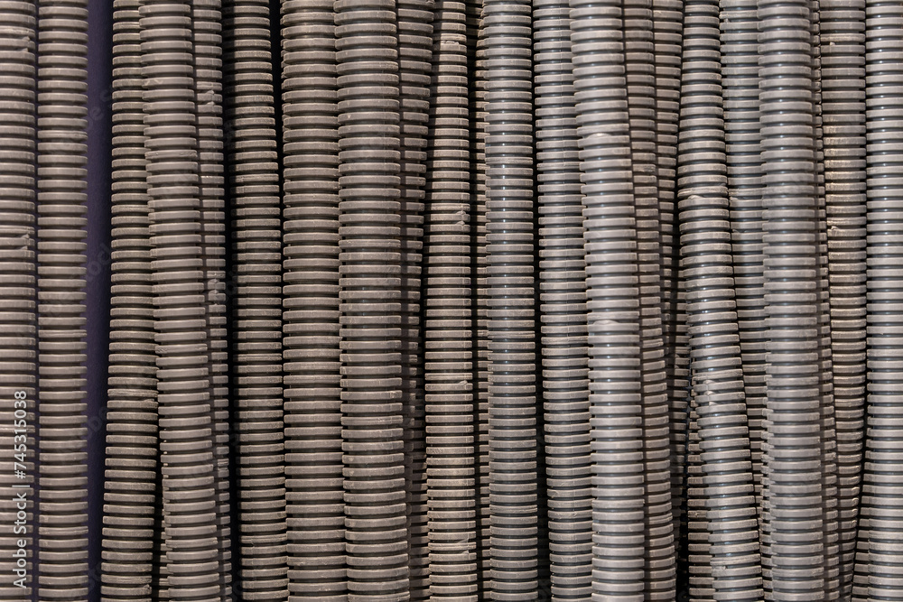 Obraz premium Close-up: Electrical conduits neatly align, guiding cables with precision. Structured arrangement showcases efficient wiring infrastructure.