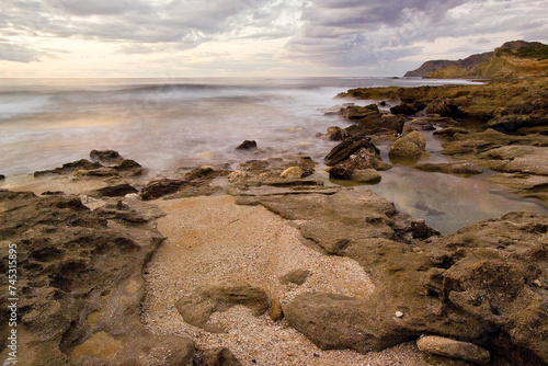 rocks on the beach at sunset, Coast of Argentiera near La Frana. SS, Sardinia, Italy