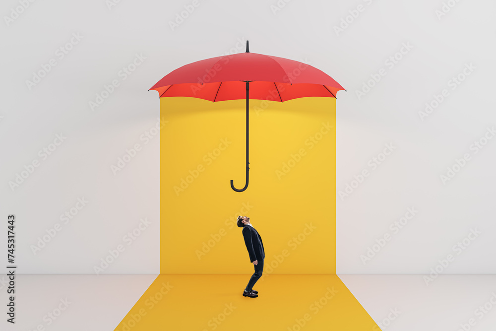 A conceptual image of a man staring at a floating red umbrella on a vibrant yellow background, depicting protection and inquisitiveness A conceptual image of a man staring at a floating red umbrella on a vibrant yellow background, depicting protection and inquisitiveness