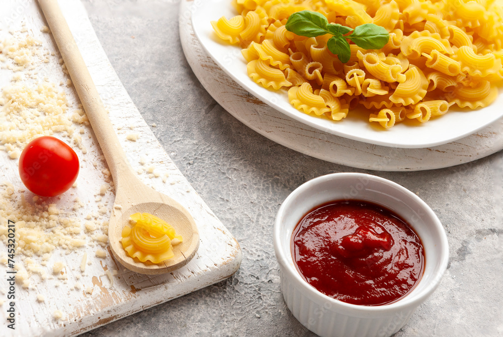 Uncooked Creste di Gallo pasta and ingredients for it cooking Uncooked Creste di Gallo pasta and ingredients for it cooking