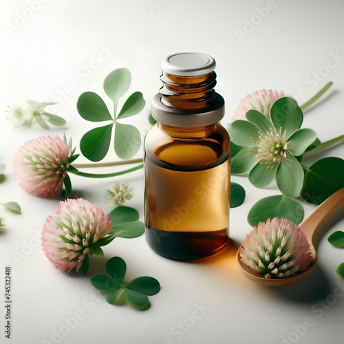 glass bottle of clover essential oil on white background