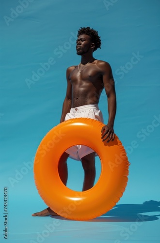 man with beach float on a blue background, light yellow and dark orange