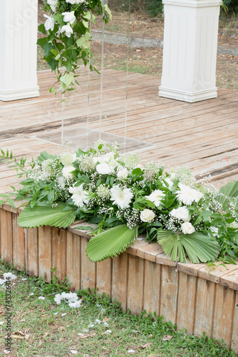 wedding dais. Wedding ceremony area. White wooden boxes on a green lawn. Wedding festal arch. 