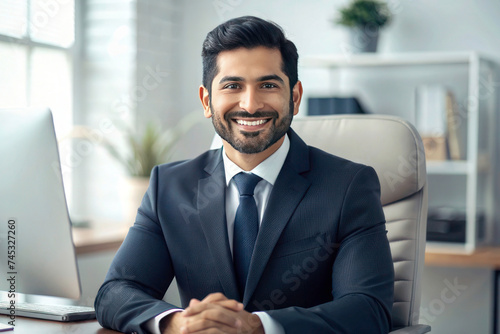 Young Hispanic Businessman in Business Suit: Portrait of Satisfied Boss Smiling and Looking at Camera Inside Office © Tapos