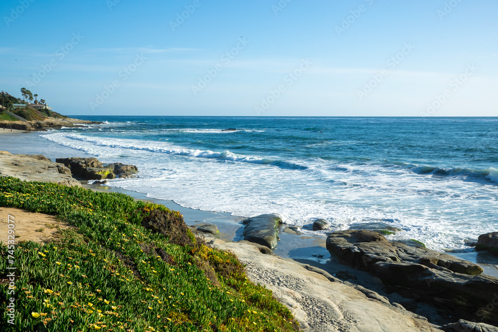 Rocky and foamy ocean shore in San Diego