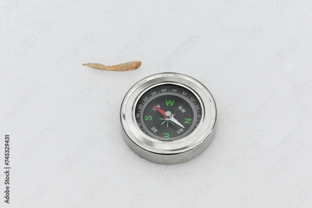 A compass in the snow. A compass in the snow.
