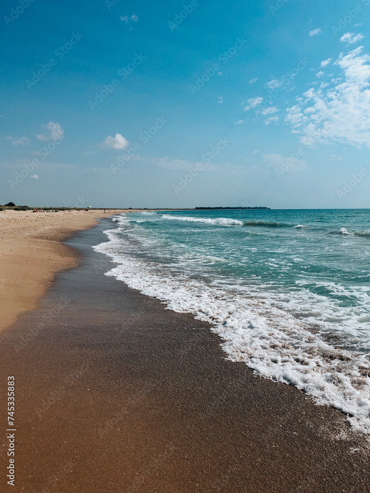 Sea blue aquamarine waves line sunny sand beach. Soft wave of ocean foam.