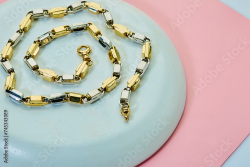 Gold chain on two tone background